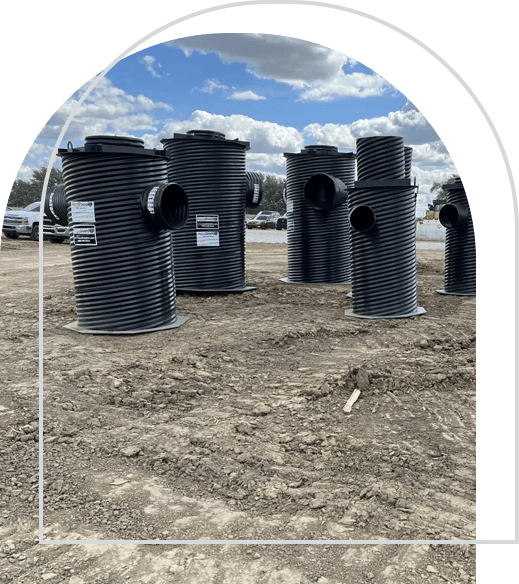 A group of black pipes sitting in the middle of a field.