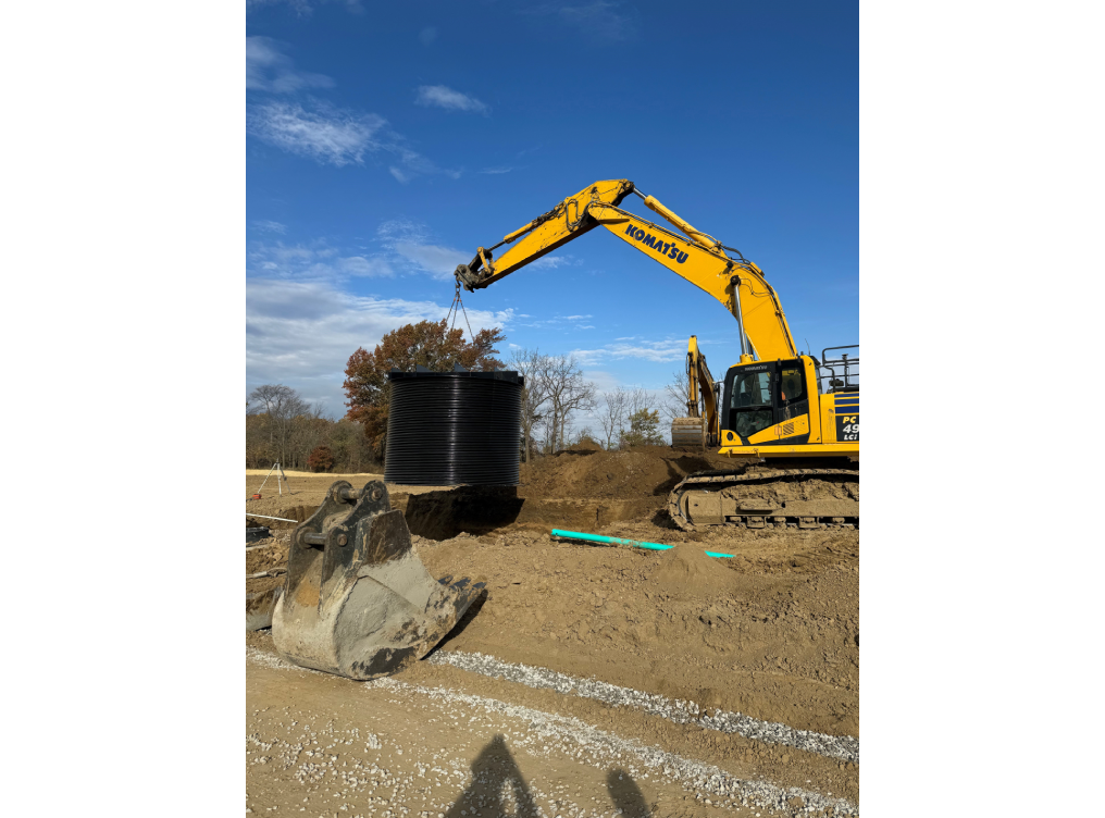 A yellow and black excavator is on the ground